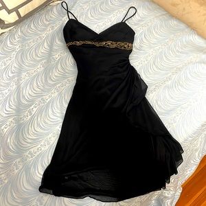 Little black dress with gold accent piece.